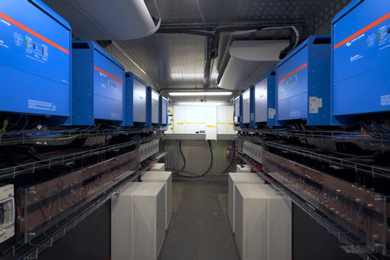 Victron inverter/chargers and battery cabinets installed inside a microgrid container